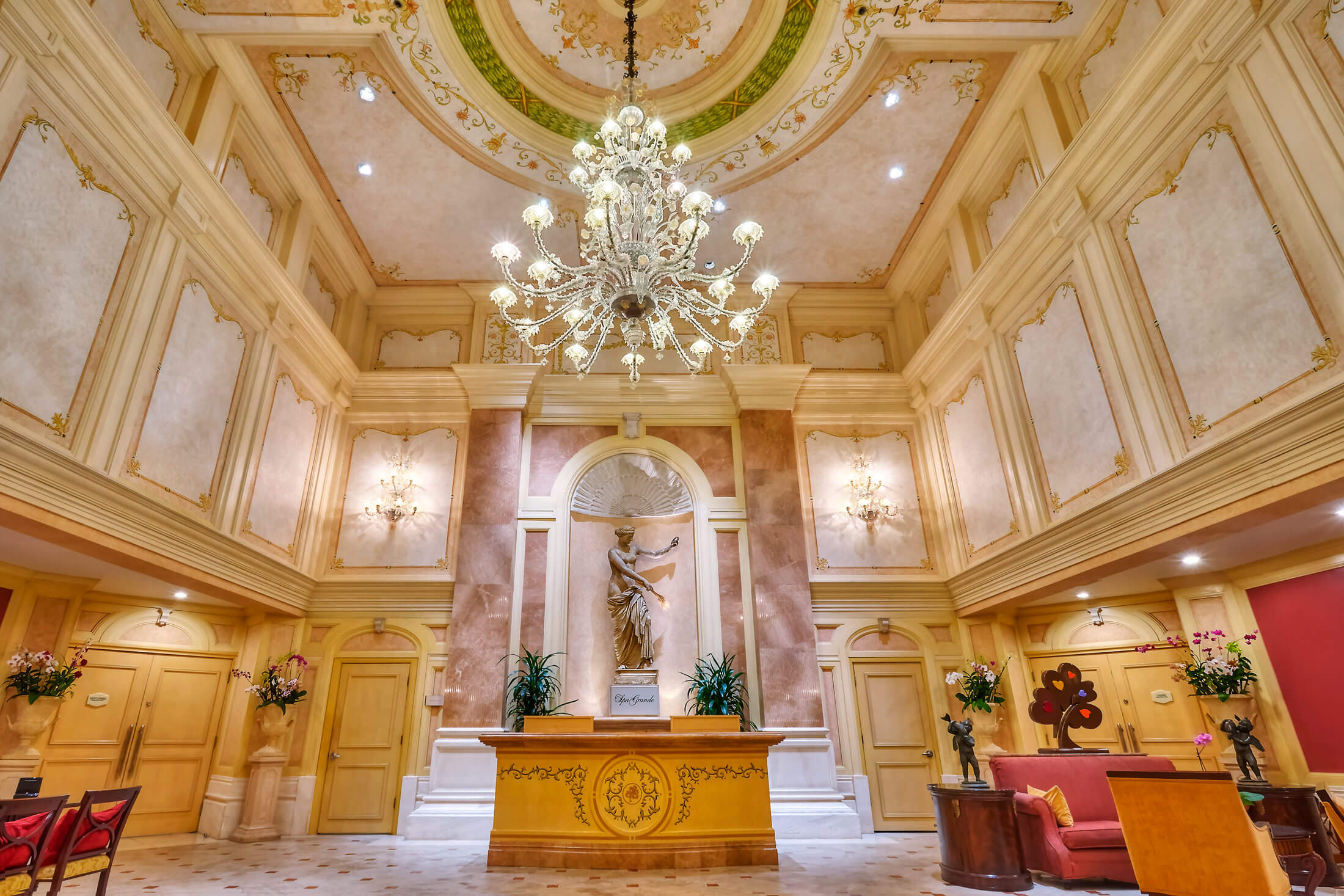 a chandelier hangs in the spa grande reception area