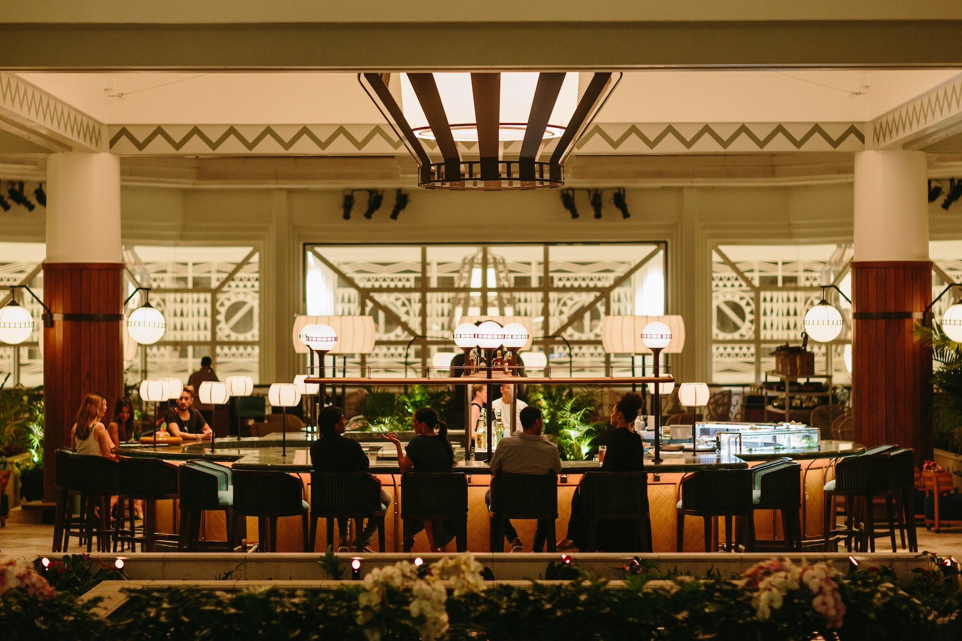 A large restaurant dining room with large communal tables and wide windows