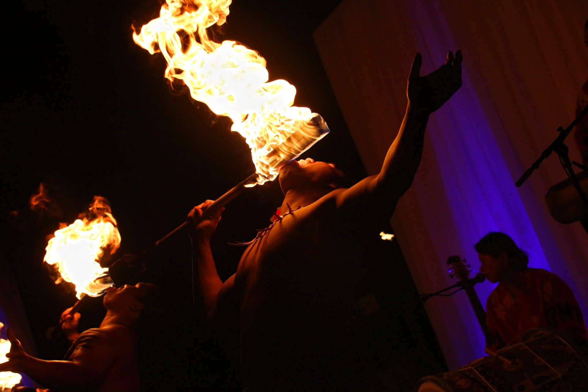 A group of fire breathers perform at a Luau