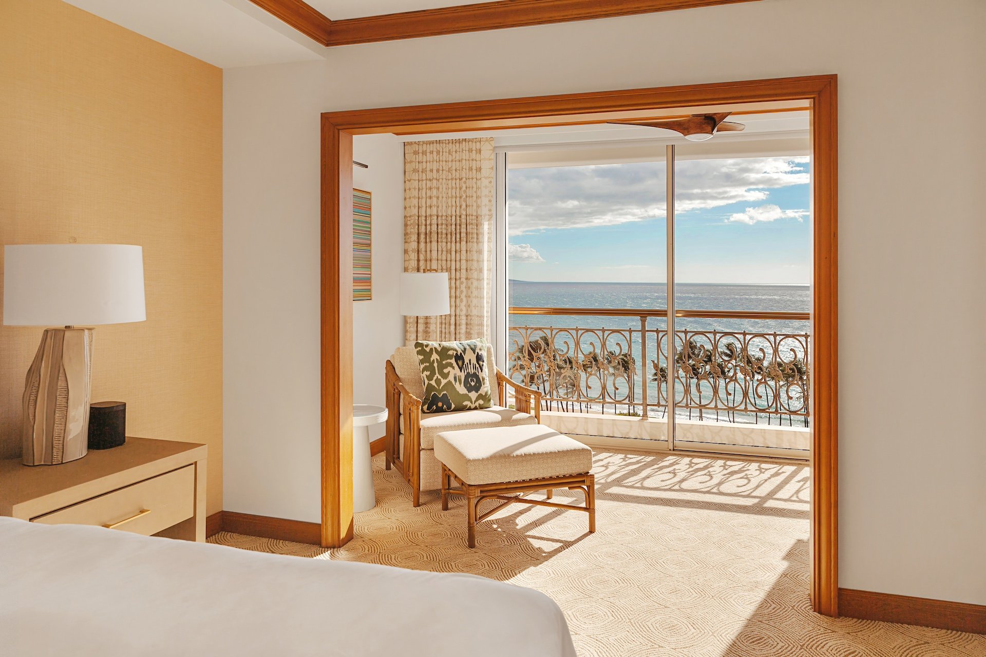 The view of the ocean from a bed in a resort suite