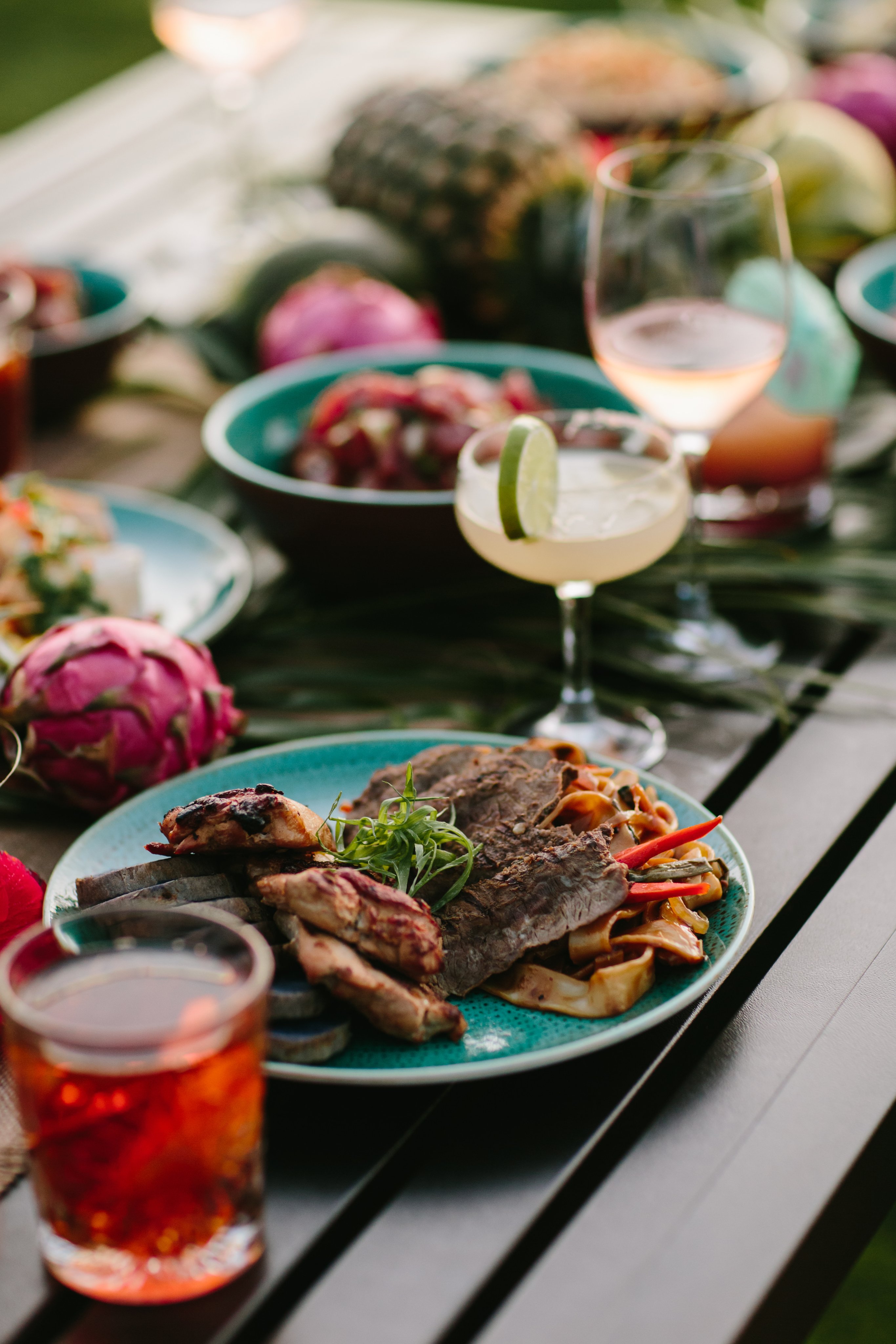 A table with plates of steaks and drinks