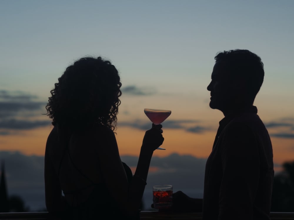 A couple enjoys cocktails at dusk