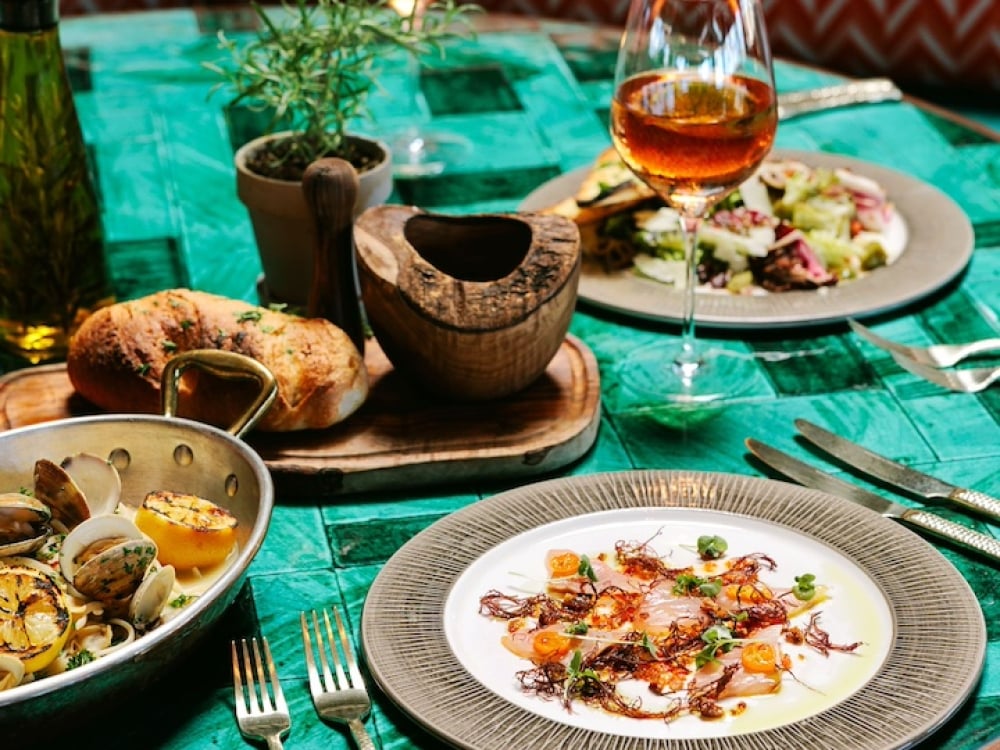 A table full of dishes in a booth at Olivine restaurant