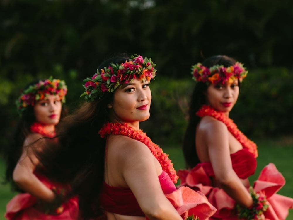 Luau dancers posing at dusk