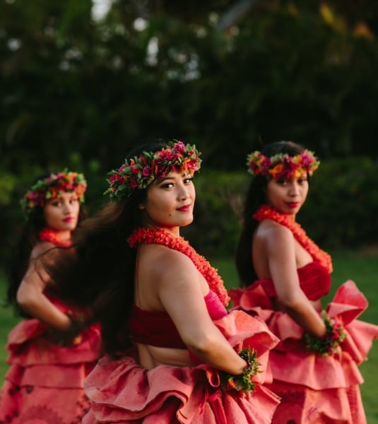 Luau dancers posing at dusk