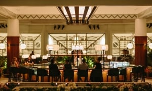 A large restaurant dining room with large communal tables and wide windows