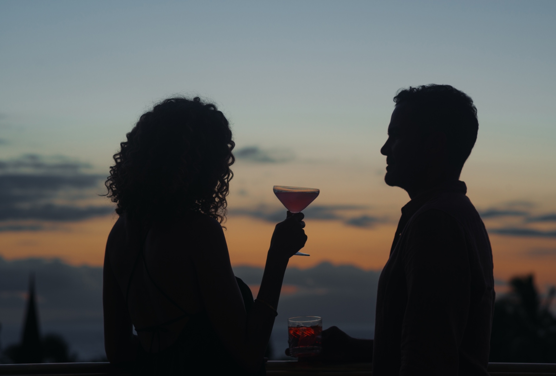 A couple enjoys cocktails at dusk