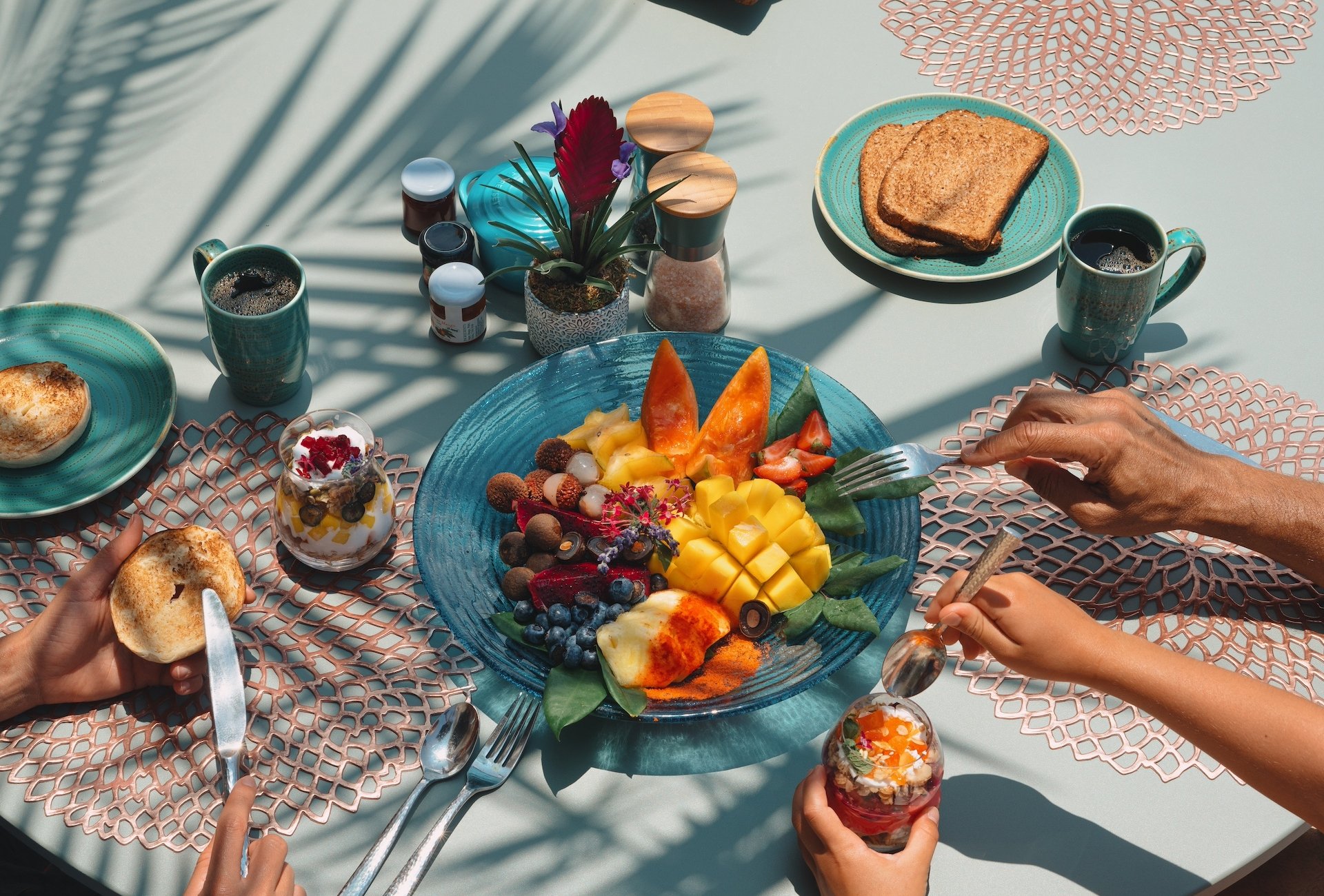 A plate of fresh tropical fruit on an outdoor patio table