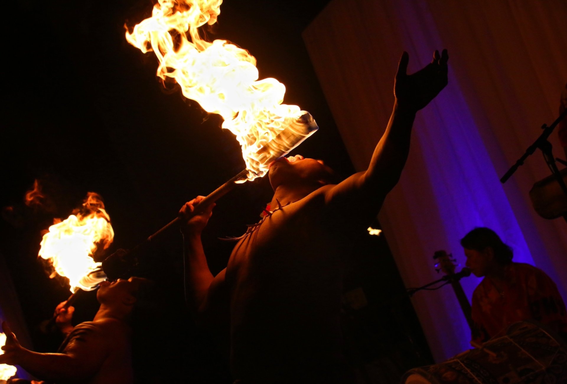 A group of fire breathers perform at a Luau