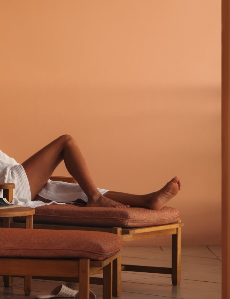 A woman sitting on a lounge chair