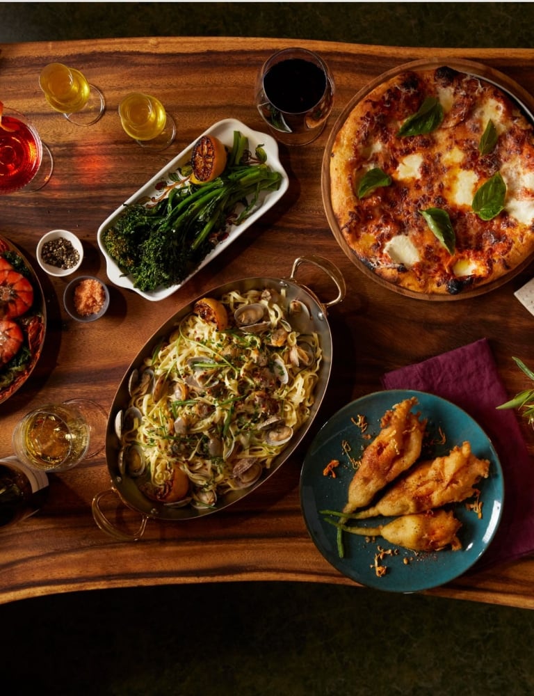 A wood table covered with a variety of dishes
